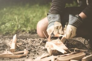 camping survival person_cutting_wood